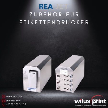 Automatisches Bulk System für REA JET Inkjet Drucker, bestehend aus zwei silbernen Gehäusen, eines mit Tintentank und eines mit verschiedenen Anschlüssen für die kontinuierliche Tintenversorgung.